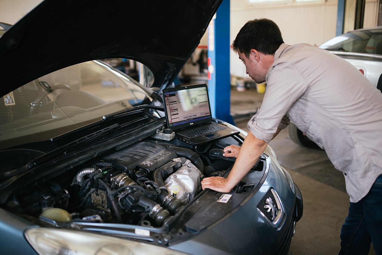 Technician running diagnostics on a vehicle
